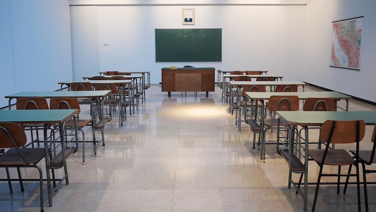 Empty classroom with desks representing schools and education