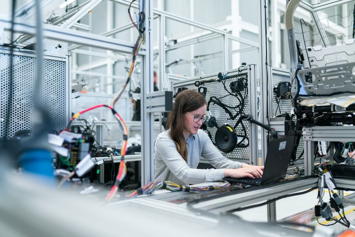 Engineer working with industrial equipment on a manufacturing floor